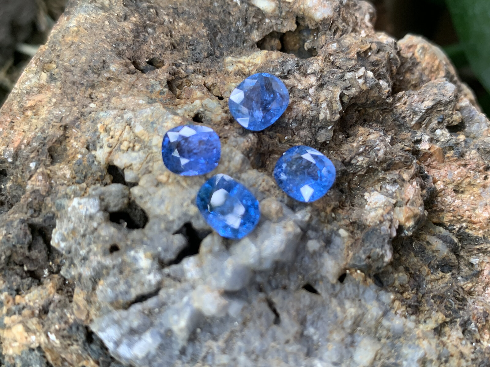 Faceted cobalt blue spinel resting on the marble host rock it was broken out of