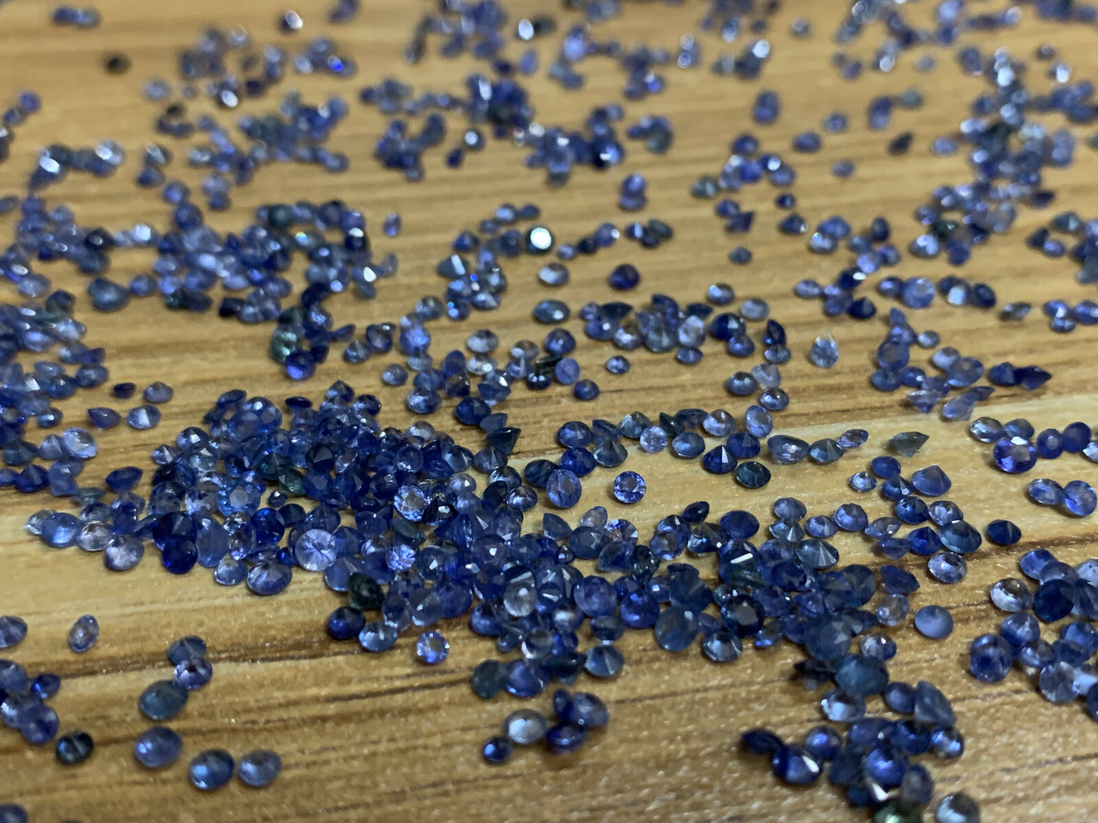 A parcel of small natural blue sapphires from Vietnam laid out for sorting