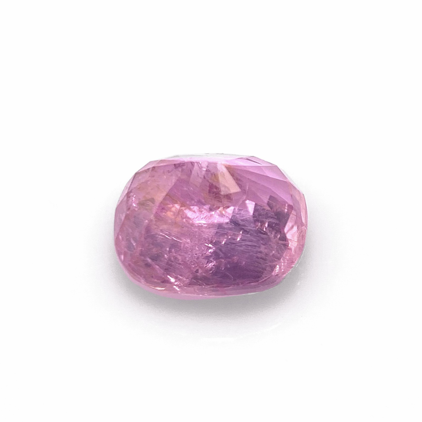 Unheated pink milky sapphire side angle on white background