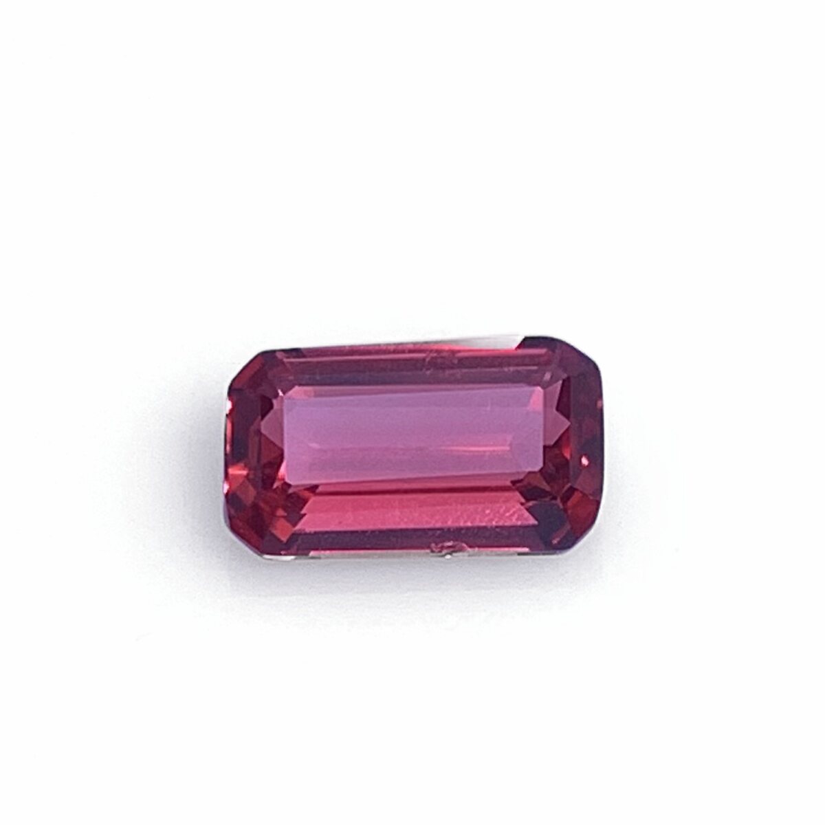 Natural vivid pinkish red (raspberry) spinel 0.87 ct from Luc Yen Vietnam, face up on white background