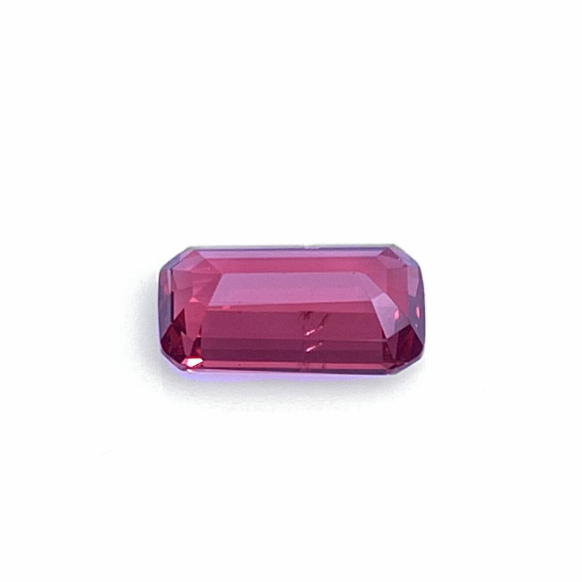 Natural vivid pinkish red (raspberry) spinel, pavilion view on white background