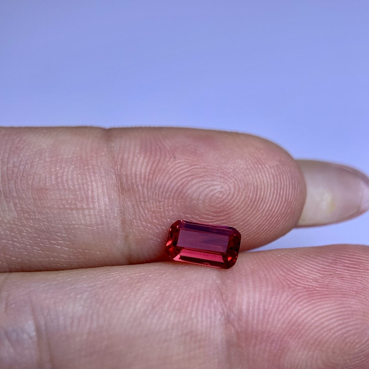 Natural vivid pinkish red (raspberry) spinel from Luc Yen held in daylight