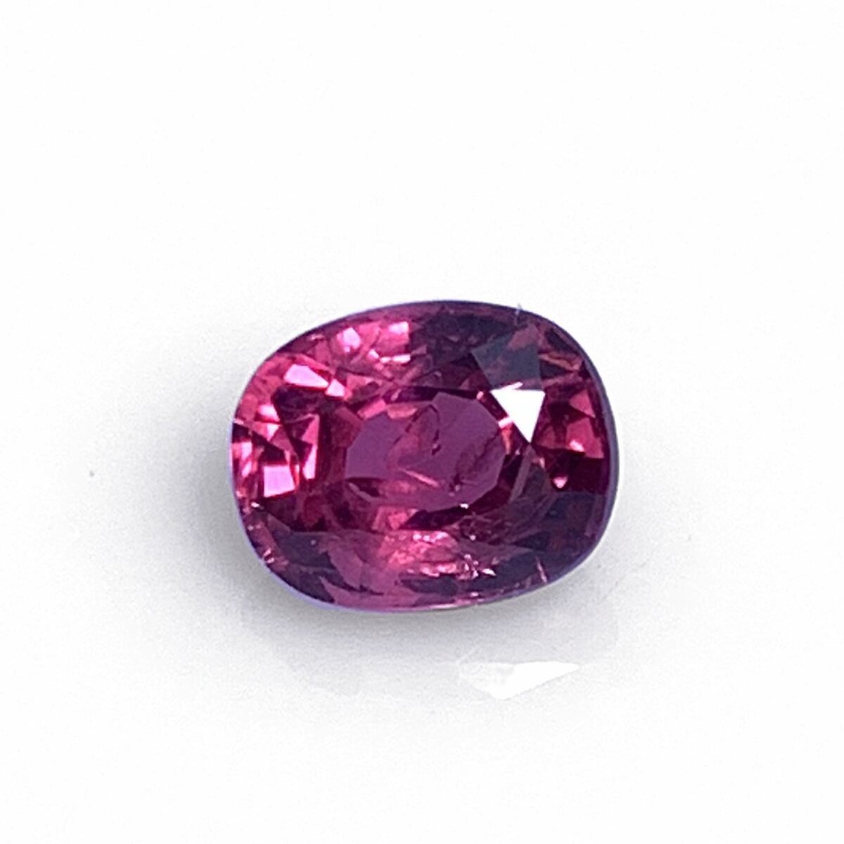 Natural vivid pinkish red spinel 0.75 ct from Luc Yen Vietnam, face up on white background