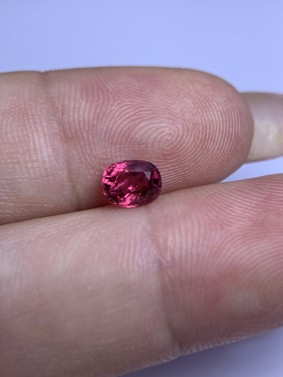 Natural vivid pinkish red spinel from Luc Yen held in daylight