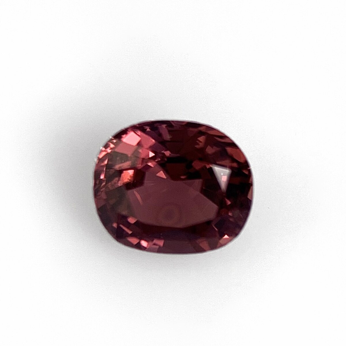 Pink spinel 0.66 ct cushion, face up on white
