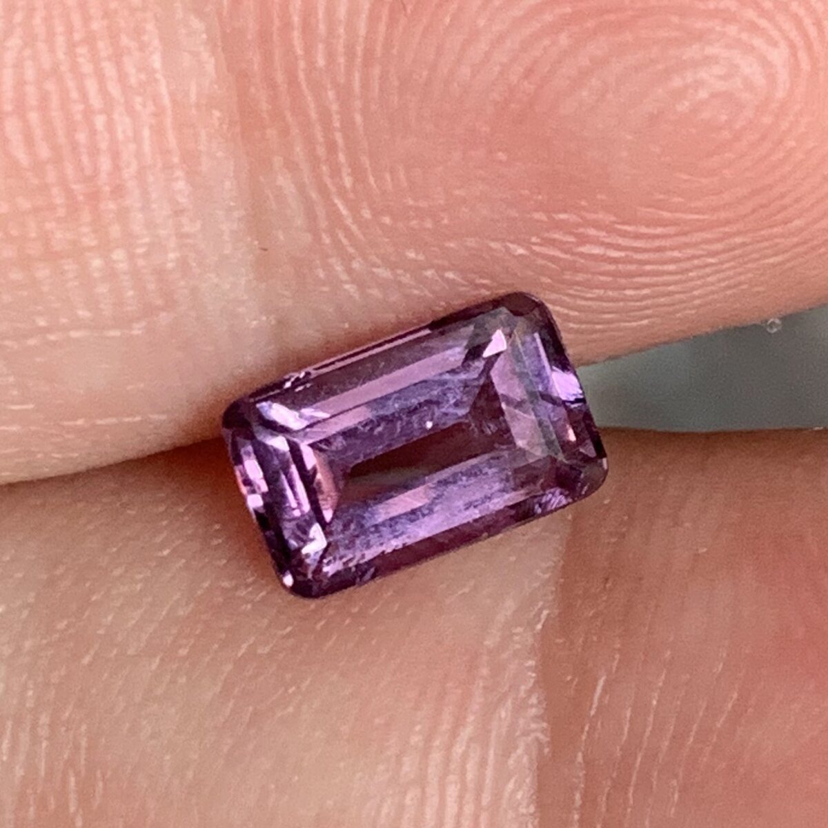 Natural purplish pink spinel from Luc Yen held in daylight