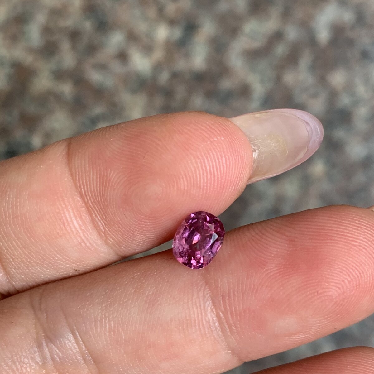 Natural purplish pink spinel from Luc Yen held in daylight