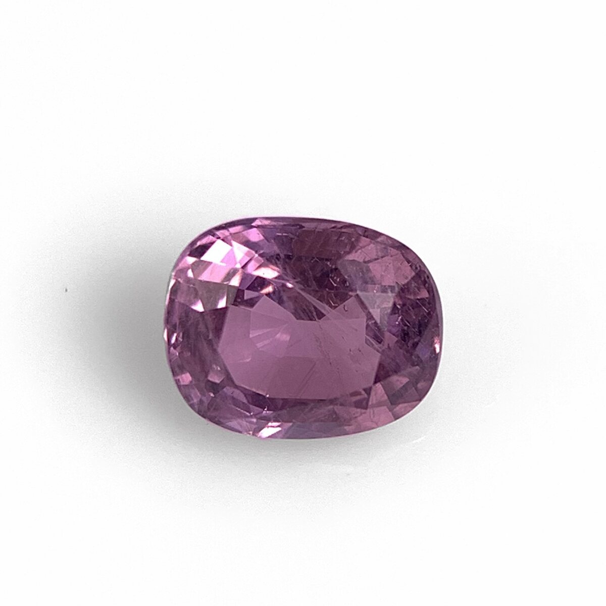 Natural purplish pink spinel 0.97 ct from Luc Yen Vietnam, face up on white background