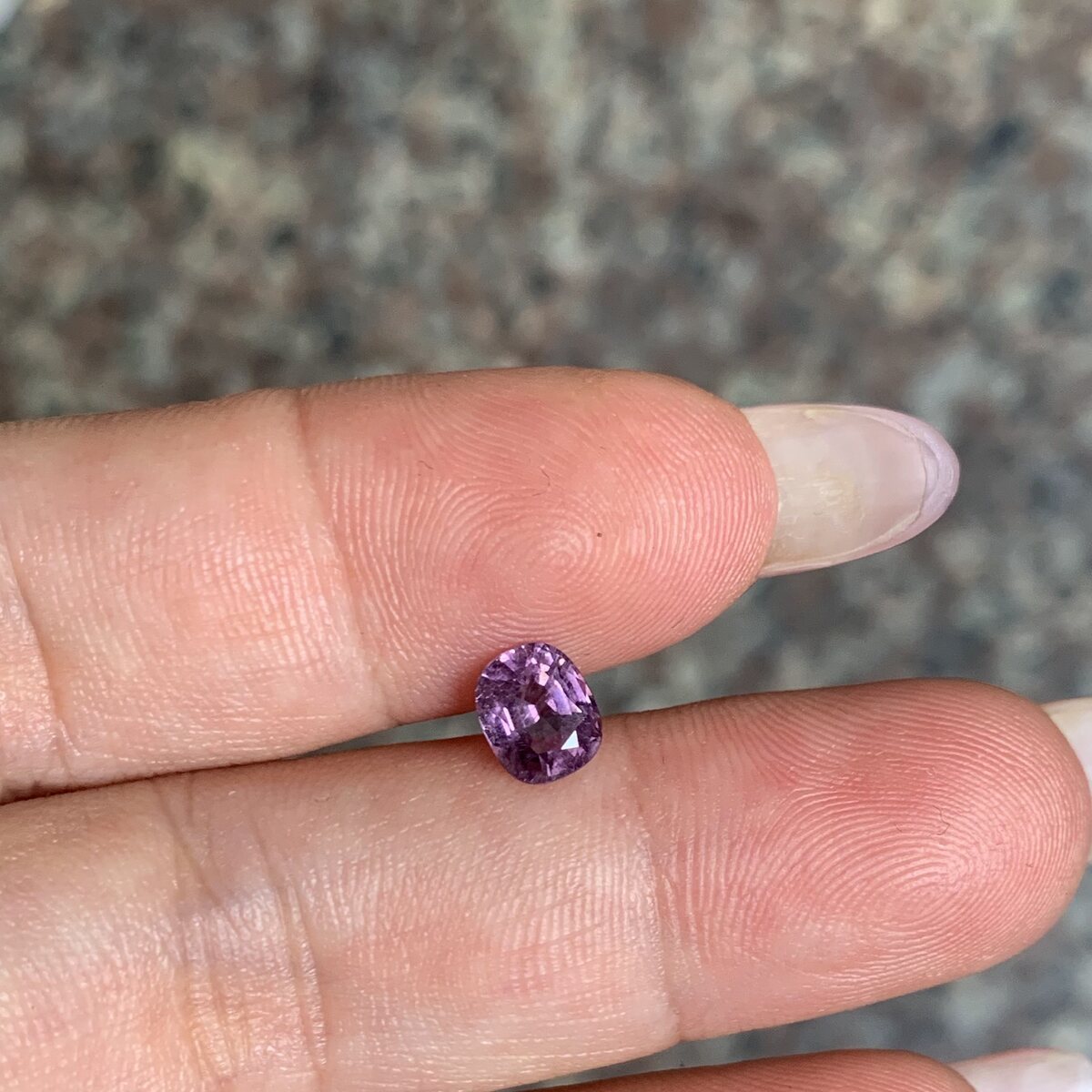 Natural purplish pink spinel from Luc Yen held in daylight
